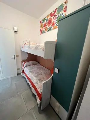 a small room with a bunk bed and a door at Casa vacanza galatea San vito lo capo in San Vito lo Capo