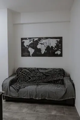a bed in a room with a map on the wall at House Paradise- House Arena in Porticello