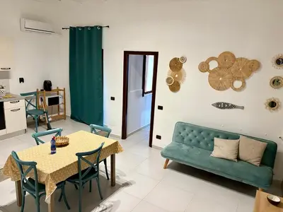 a living room with a couch and a table at Kiko Dodi House Mondello in Palermo
