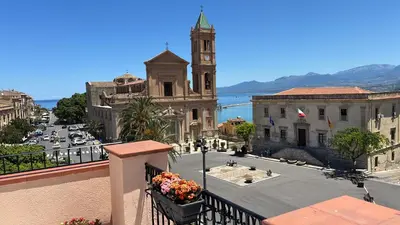 a view from a balcony of a city with a church at Casa Vacanze Mazzini, amazing Rooftop! in Termini Imerese