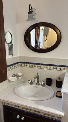 a bathroom with a sink and a mirror at Casa Vacanze Mazzini, amazing Rooftop! in Termini Imerese