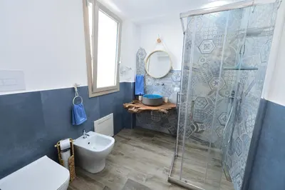 a bathroom with a shower and a toilet and a sink at Ummi Taliari in Terrasini