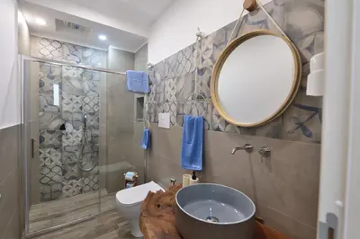 a bathroom with a sink and a mirror and a toilet at Ummi Taliari in Terrasini