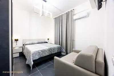 a bedroom with a bed and a couch at Calatafimi House in Palermo