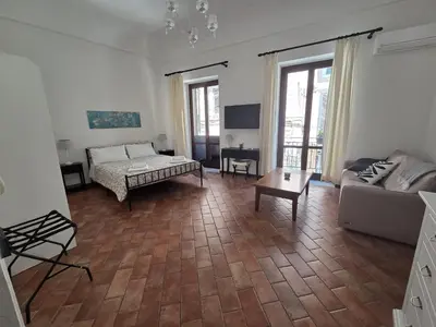 a living room with a couch and a table at A Casa di Iside in Palermo