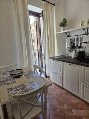 a kitchen with a table and a table and chairs at A Casa di Iside in Palermo