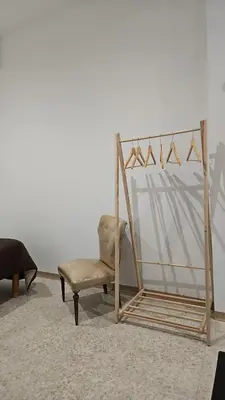 a chair and a mirror in a room at La Corte Di San Basilio palermo in Palermo