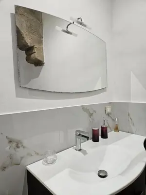 a bathroom with a sink and a mirror at La Corte Di San Basilio palermo in Palermo