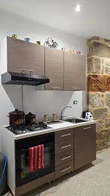 a kitchen with a stove and a sink at La Corte Di San Basilio palermo in Palermo