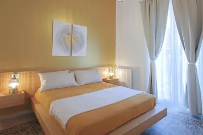a bedroom with a large bed and a window at Suites Santa Cecilia in Palermo