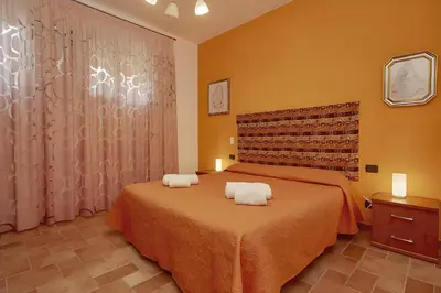 a bedroom with a bed with two towels on it at Casa vacanza Onda Lunga in Alcamo