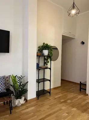 a living room with a shelf with plants on it at Matteo's House in Palermo