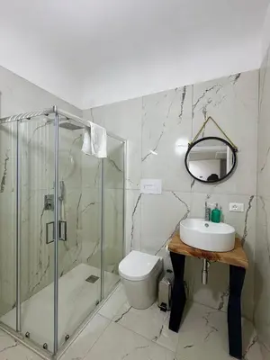 a bathroom with a shower and a toilet and a sink at Ai Limoni in Palermo