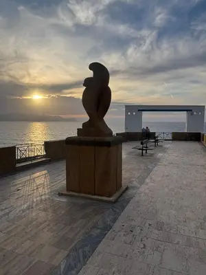 a statue on a pier with the ocean in the background at Casa Miramara Sicilia in Balestrate