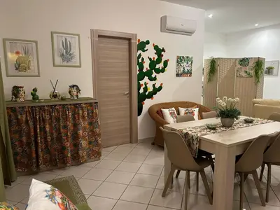 a dining room with a table and chairs at Sweet World in Terrasini