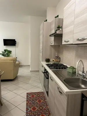 a kitchen with a sink and a stove top oven at Sweet World in Terrasini