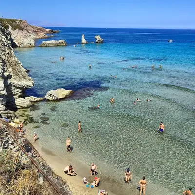 a group of people in the water at a beach at Sweet World in Terrasini