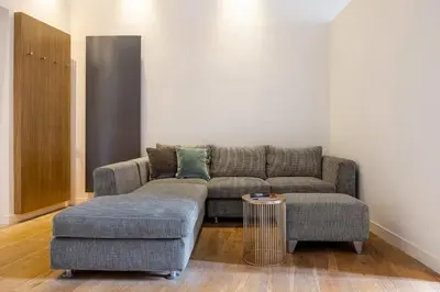 a living room with a couch and a table at Mani San Domenico by DomuSicily in Palermo