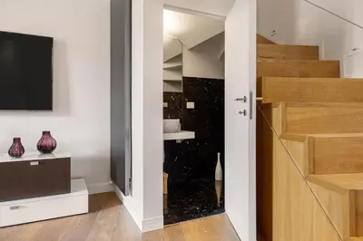 a room with a sliding glass door and a tv at Mani San Domenico by DomuSicily in Palermo