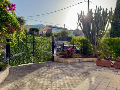 a gate to a garden with a cactus at Merlo Holiday Homes Mare in Trabia