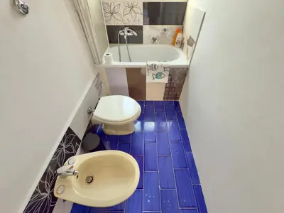 a small bathroom with a sink and a toilet at Merlo Holiday Homes Mare in Trabia