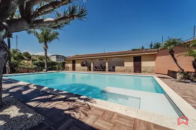a swimming pool in the backyard of a villa at Huge Villa with Stunnig Pool in Partinico