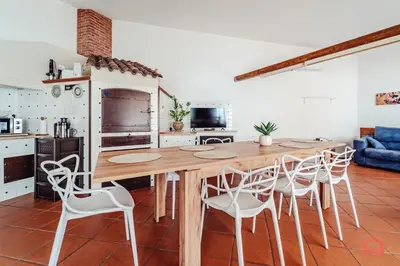a kitchen with a large wooden table and chairs at Huge Villa with Stunnig Pool in Partinico