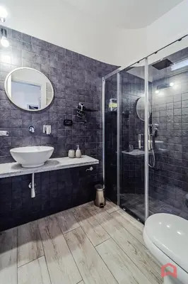 a bathroom with a sink and a glass shower at Huge Villa with Stunnig Pool in Partinico