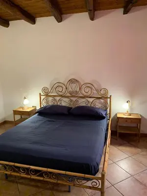 a bed in a bedroom with two nightstands and two lamps at Casa Ballarò Centro Storico in Palermo