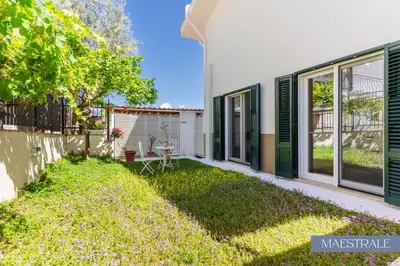 a house with green shutters and a yard at Baida Apartments in Palermo