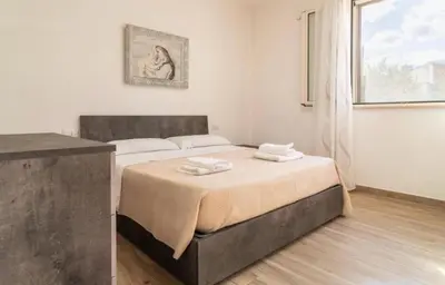 a bedroom with a bed with two towels on it at Villa a due passi dal mare in Mandra Capreria