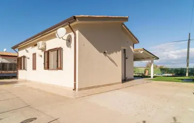 a small white building with a roof at Villa a due passi dal mare in Mandra Capreria