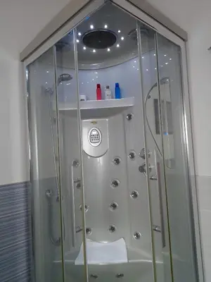 a shower in a bathroom with a glass door at Oasi Mondello in Mondello