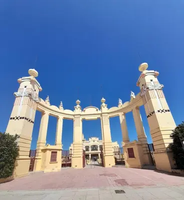 a large building with columns and a blue sky at Oasi Mondello in Mondello