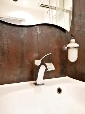 a bathroom sink with a faucet and a mirror at B&B Centro900 in Palermo