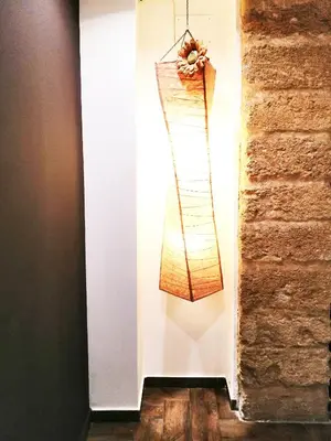 a light fixture hanging on a wall next to a brick wall at B&B Centro900 in Palermo