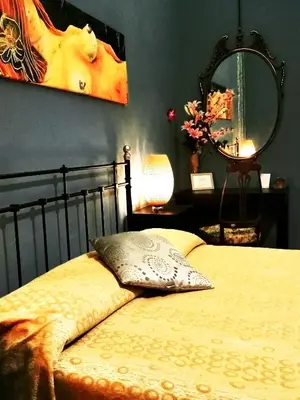 a bedroom with a bed with a pillow and a mirror at B&B Centro900 in Palermo