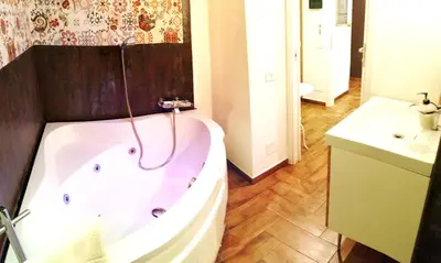 a bathroom with a bath tub and a sink at B&B Centro900 in Palermo