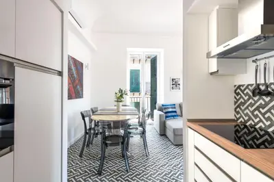 a kitchen and dining room with a small table in a kitchen at Ci' Capo Apartments by Wonderful Italy in Palermo