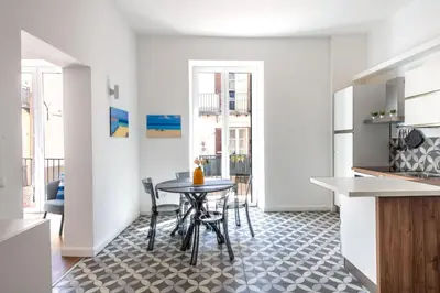 a kitchen and dining room with a table and chairs at Ci' Capo Apartments by Wonderful Italy in Palermo