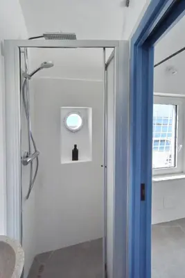 a bathroom with a shower with a glass door at Re mare exclusive home in Terrasini