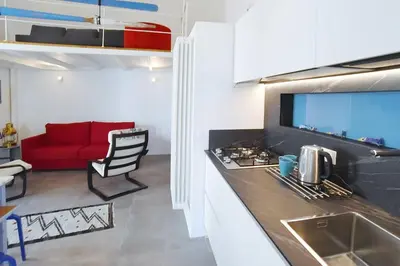 a kitchen with a red couch in a room at Re mare exclusive home in Terrasini