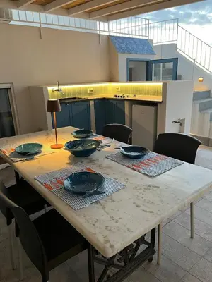 a dining room table with plates and bowls on it at Re mare exclusive home in Terrasini