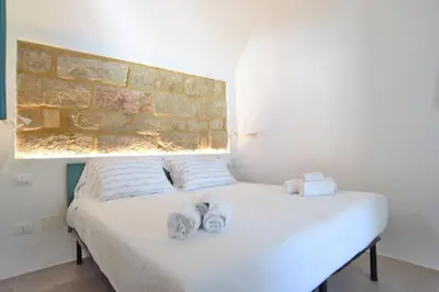 a bedroom with a bed with towels on it at Re mare exclusive home in Terrasini