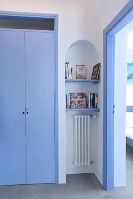 a room with a book shelf and a radiator at Re mare exclusive home in Terrasini
