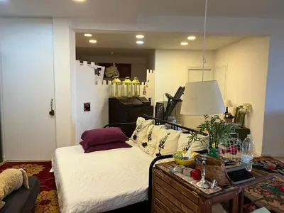 a bedroom with a bed and a table with a lamp at Villa Giulia Maria in Alcamo