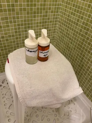 two bottles sitting on top of a toilet in a bathroom at Villa Giulia Maria in Alcamo