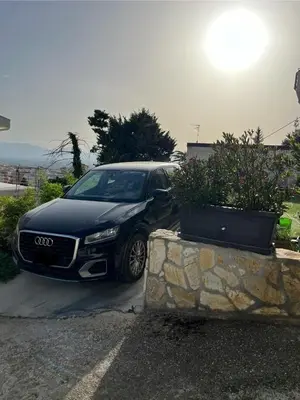 a black audi car parked in a parking lot at Villa Giulia Maria in Alcamo