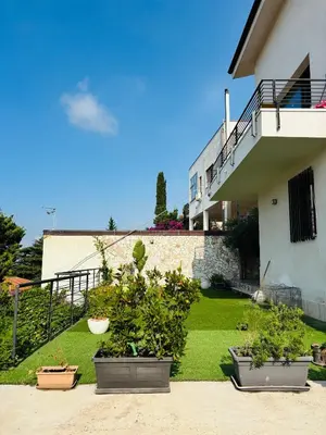 three potted plants in front of a building at Villa Giulia Maria in Alcamo