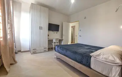 a bedroom with a bed and a desk in it at Villa Anastasia in Partinico